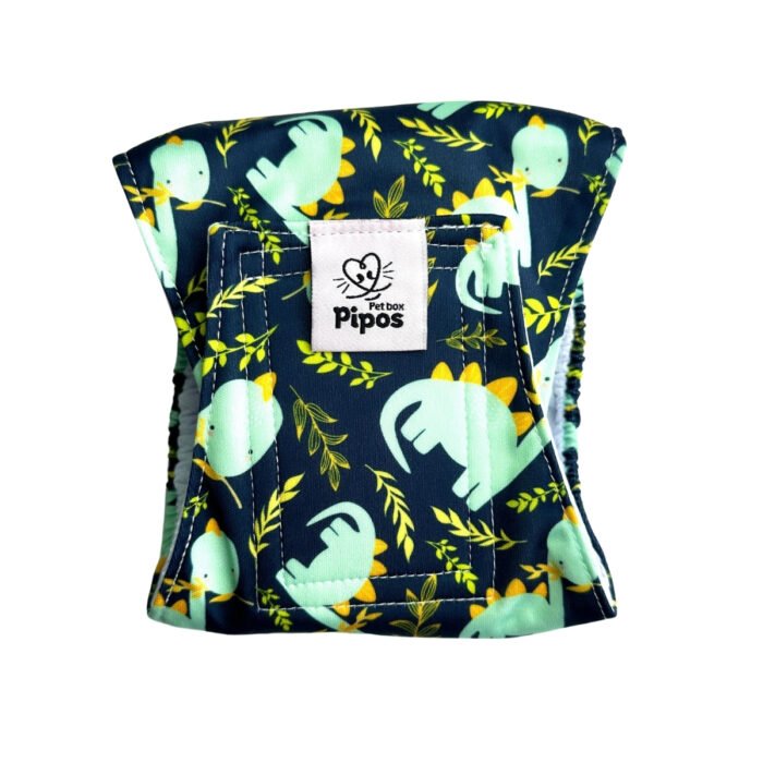 Vista frontal del pañal reutilizable para perro macho modelo Dinolandia, tipo fajín con estampado de dinosaurios verdes y hojas tropicales sobre fondo oscuro